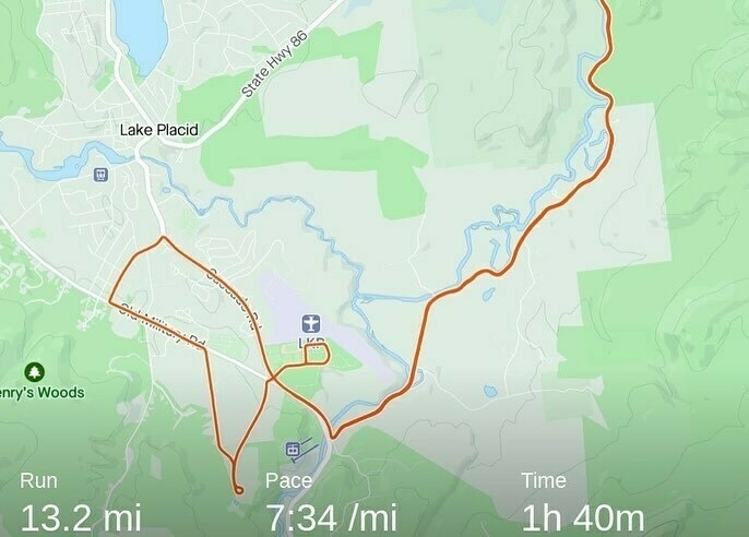 A GPS-tracked route on a map indicating a 13.2-mile run around Lake Placid, with a pace of 7:34 per mile over 1 hour and 40 minutes.