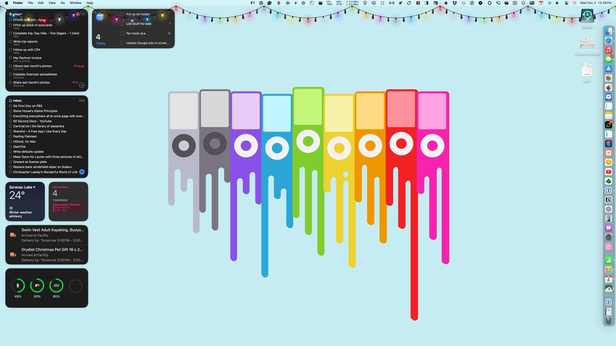 Colorful, rectangular iPod nano depictions drip vertically, resembling a spectrum, against a light blue backdrop. The desktop displays tasks, weather, and notifications. Festive lights adorn the top edge.