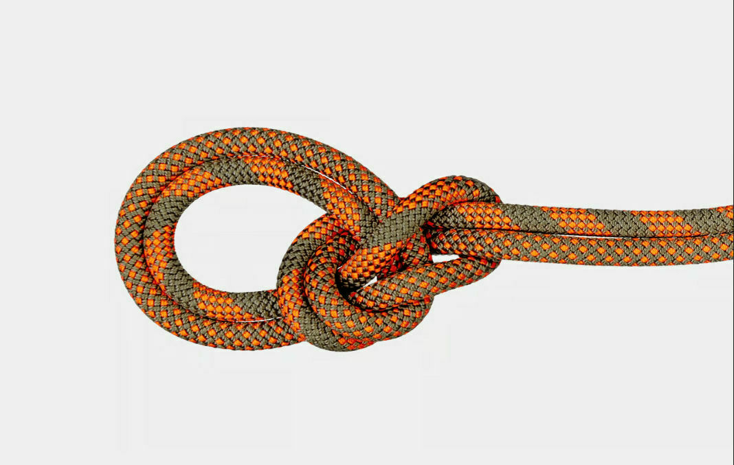 An orange and green climbing rope is tied into a bowline knot against a white background.