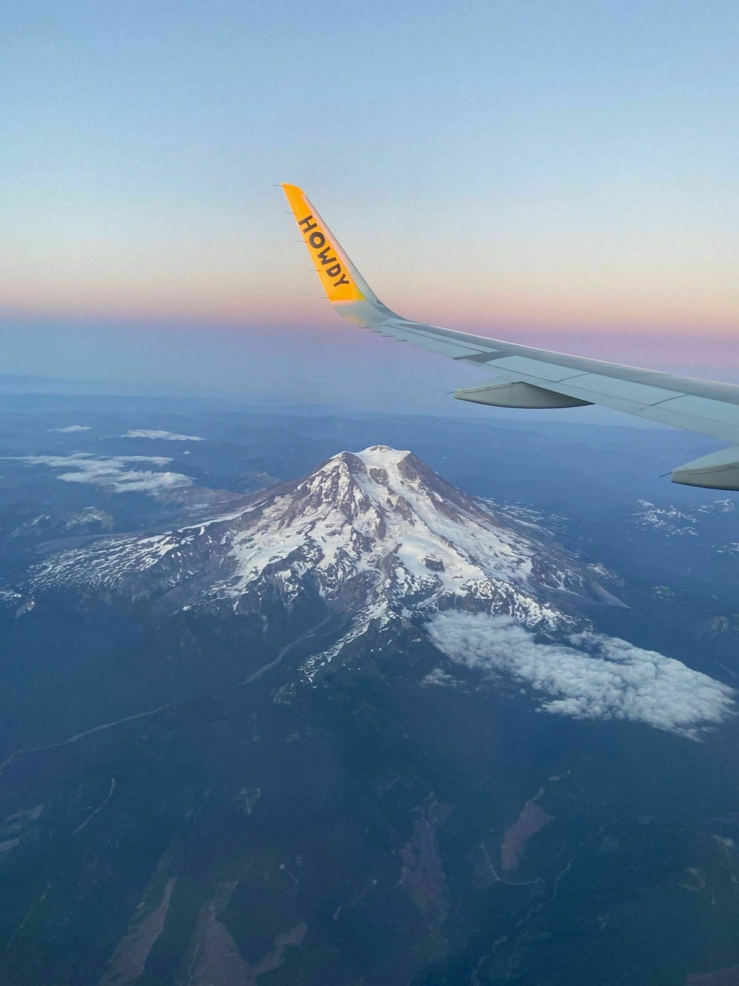 A picture from window of a plane while flying past Mount Rainier.